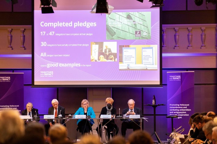 Five people in a discussion panel on stage.