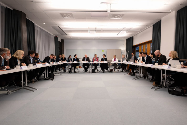 The task force gathered around tables during the meeting