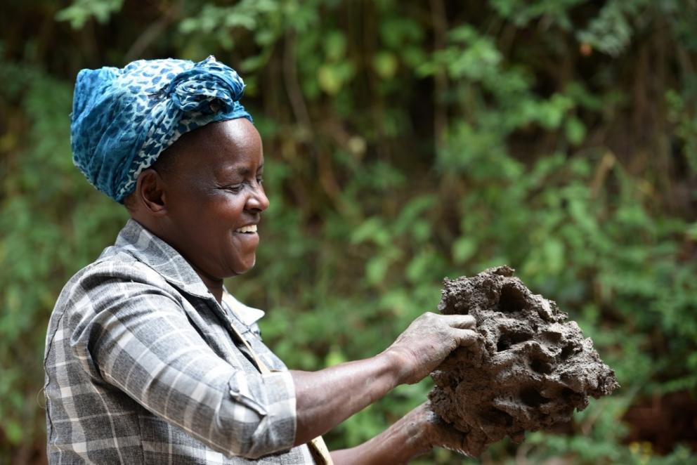 Woman holding clay.