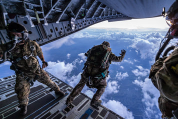 soldiers parachute jumping from an air craft